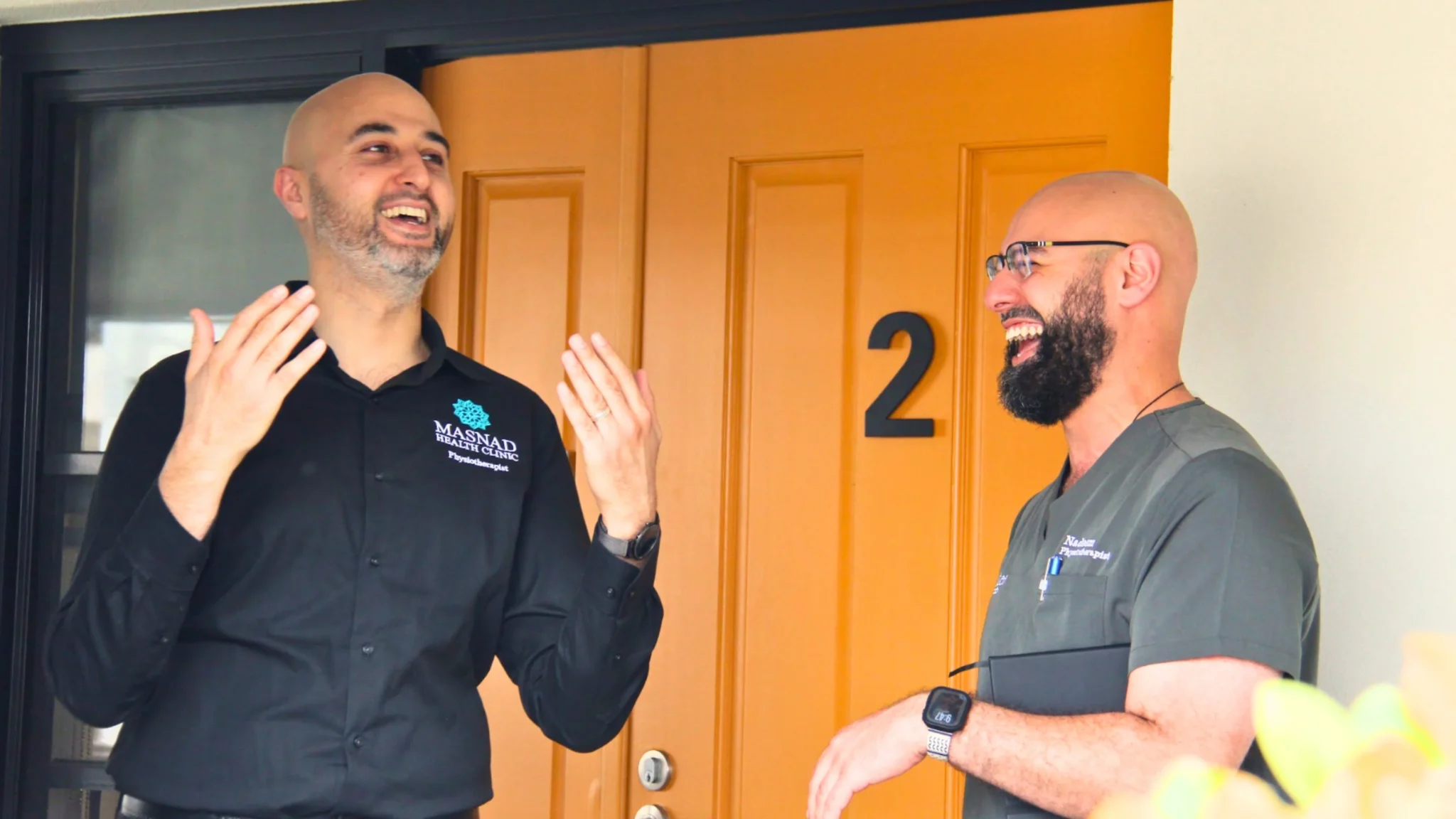 aman-aged-care-staff-laughing-doorway