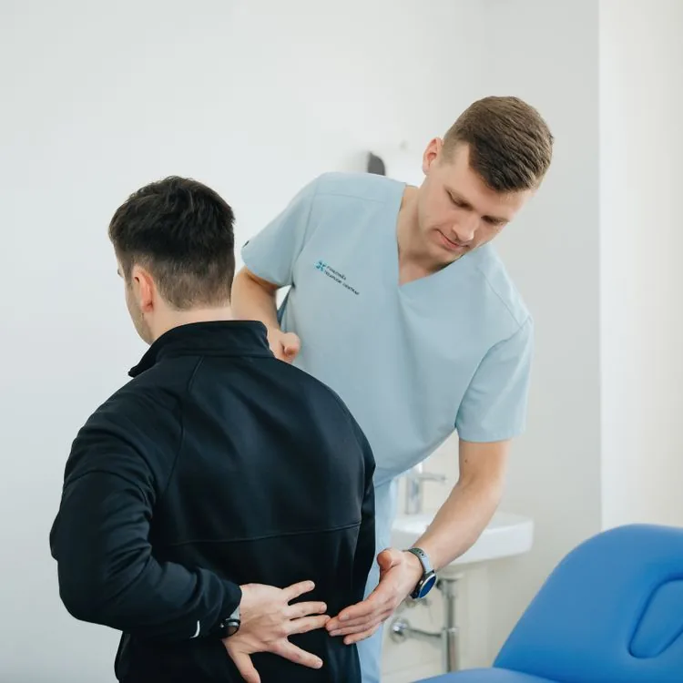 Chiropractor explaining treatment options during consultation.