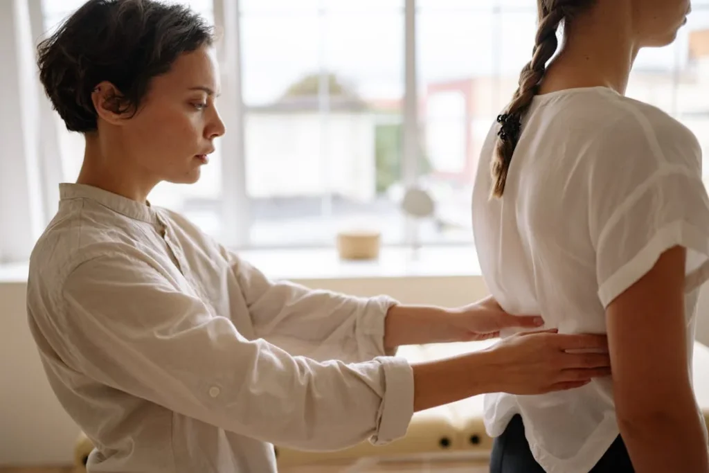 Chiropractor performing a movement and posture assessment on a patient