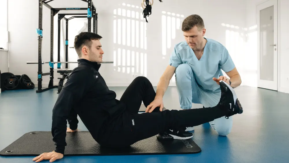 Chiropractor assessing movement and providing exercise guidance.