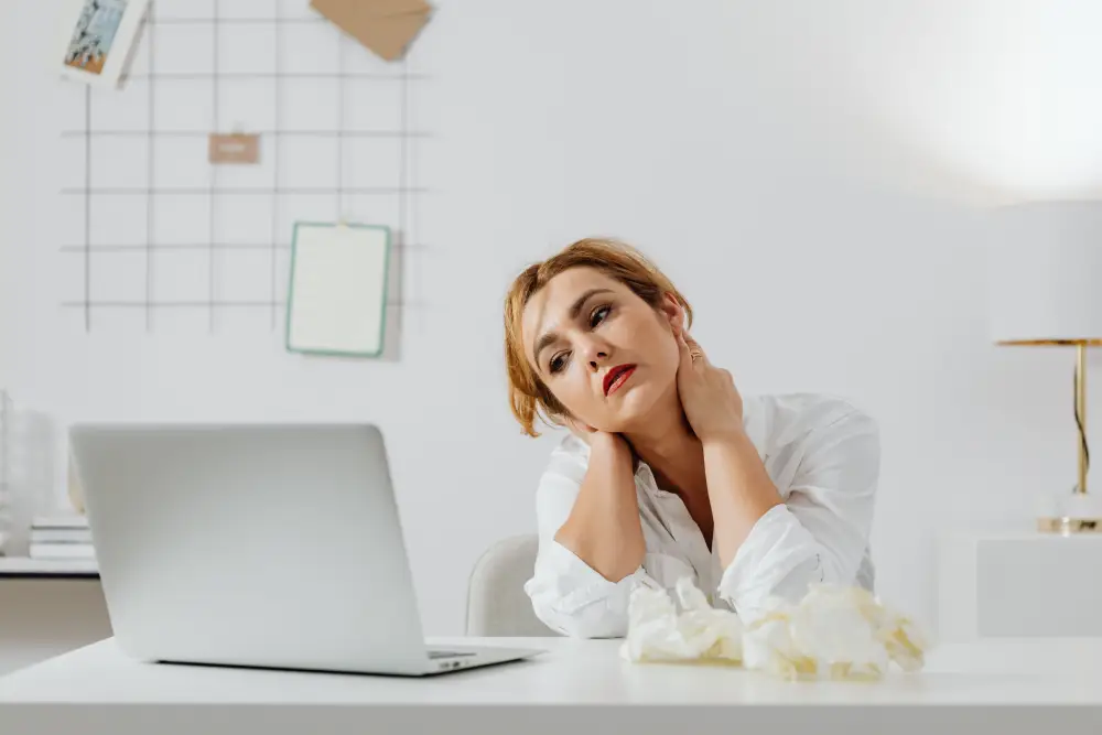 Desk worker experiencing neck and upper back discomfort.