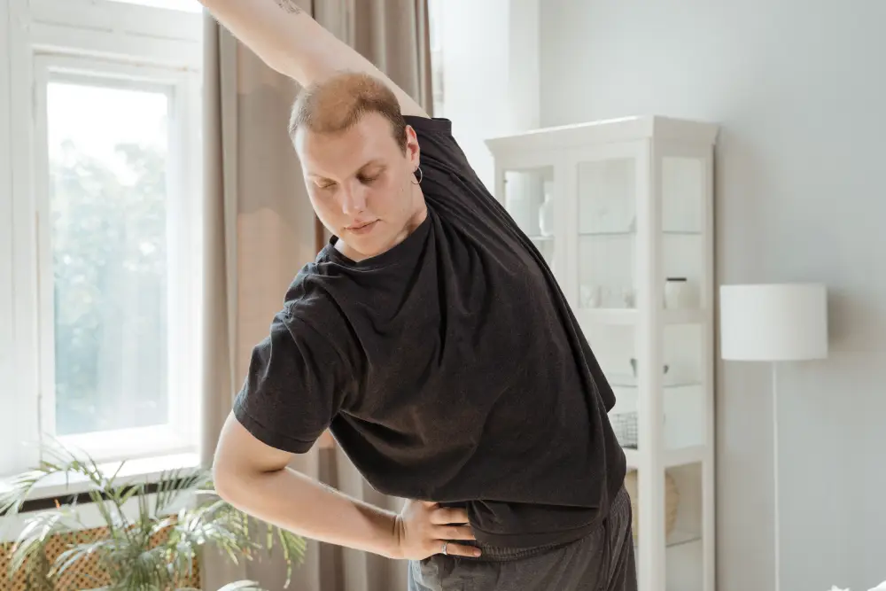 Office worker performing movement exercises during a break.